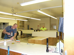 Photo of assistants working in the shop.